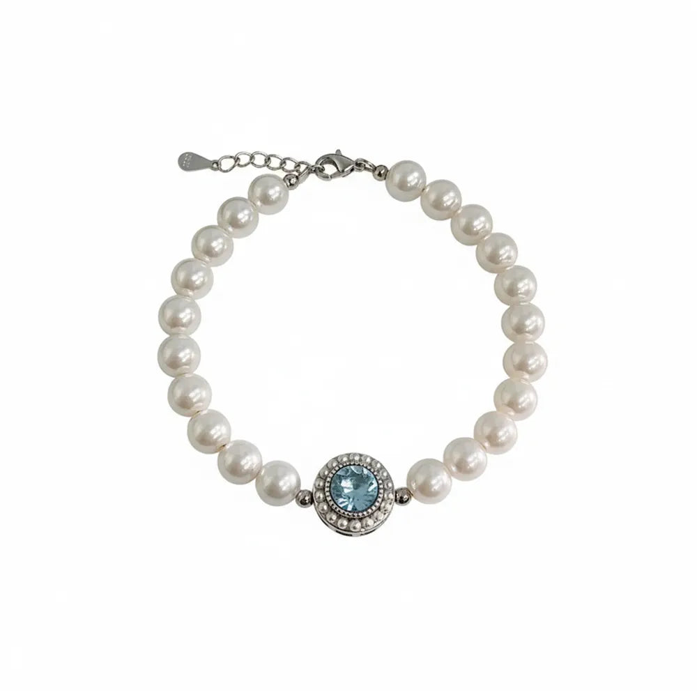S925 sterling silver bracelet featuring a strand of white pearls and a vintage round aquamarine center stone