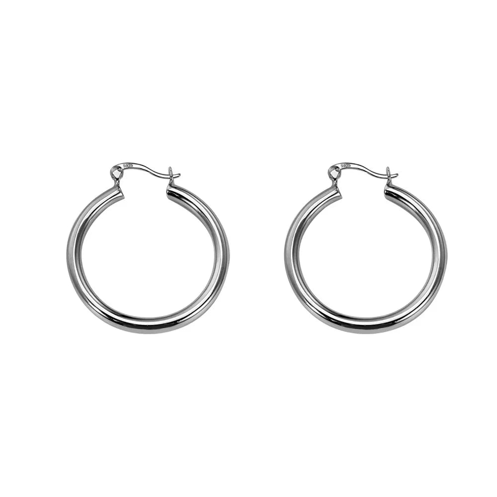 Studio shot of classic S925 sterling silver hoop earrings featuring a thick, minimalist design and mirror-like shine, isolated on white