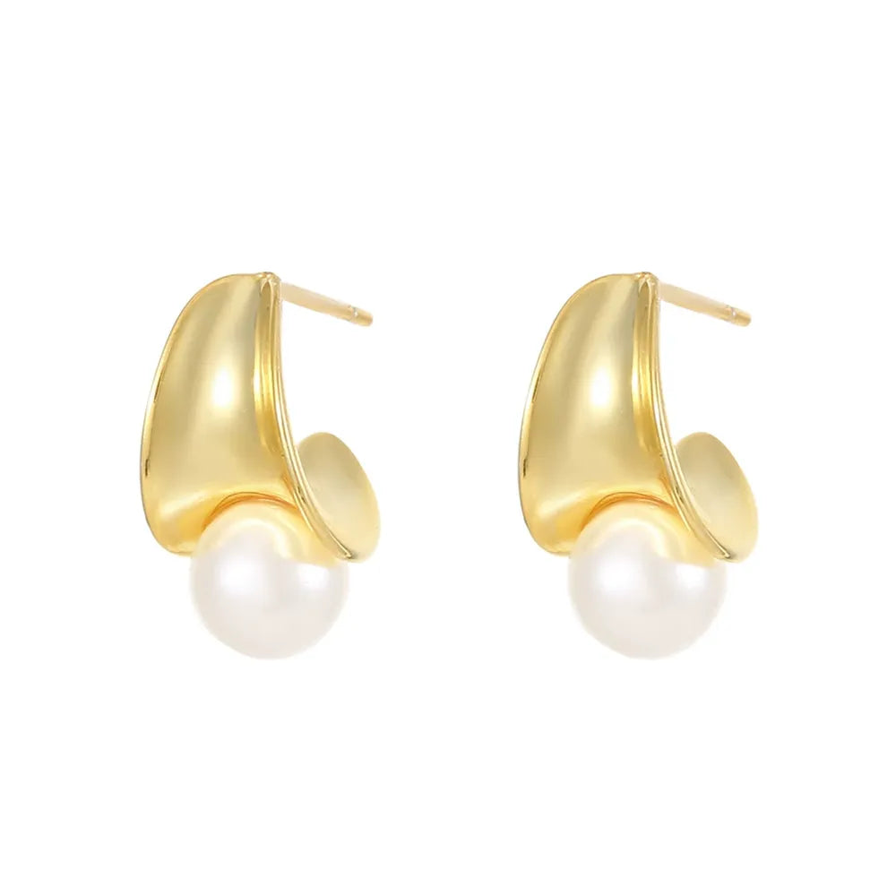 Studio shot of 18K gold plated sterling silver crescent shaped earrings with a shell pearl, isolated on white background.