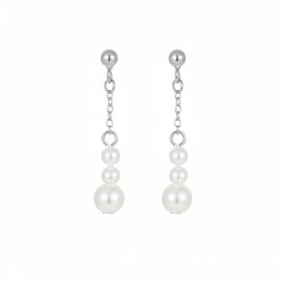Minimalist silver threader style earrings with increasing size pearls.