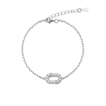S925 sterling silver chain bracelet with an oval charm filled with miniature pearls.