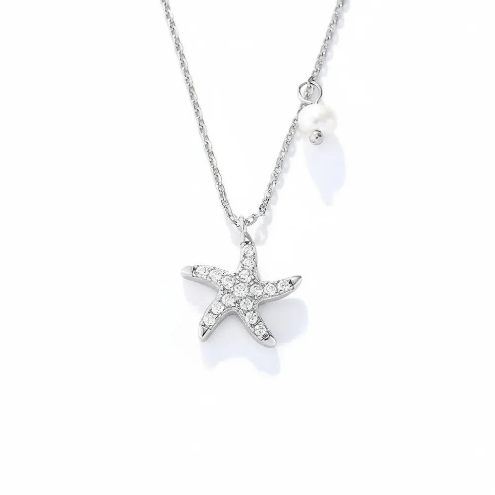 S925 sterling silver necklace featuring a sparkling starfish and pearl charm on white background.