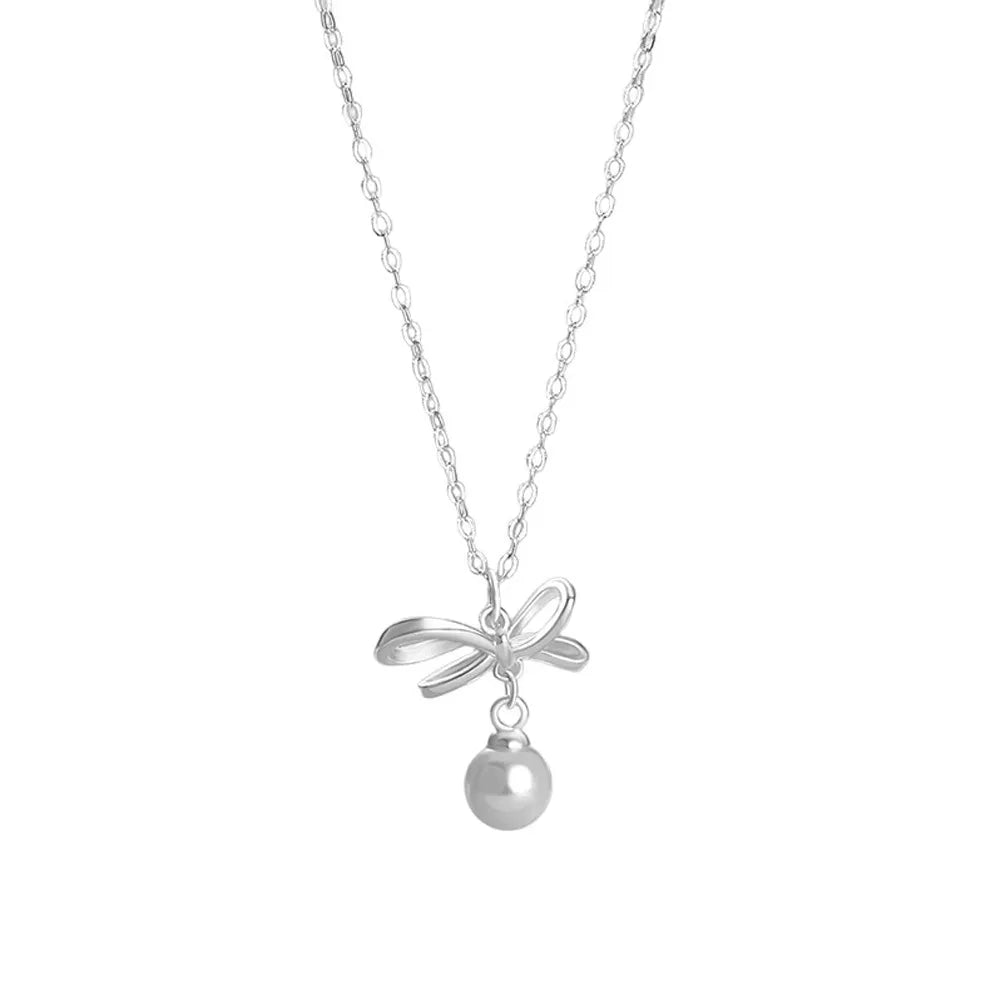 S999 fine silver necklace featuring a polished ribbon bow with a dangling shell pearl on a white background.