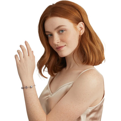 Close-up of woman wearing the elegant silver bracelet with sparkling pave cylinders.