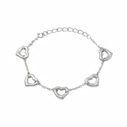 Silver 316L stainless steel bracelet with dainty open heart charms. Durable and tarnish-free jewelry on a white background.