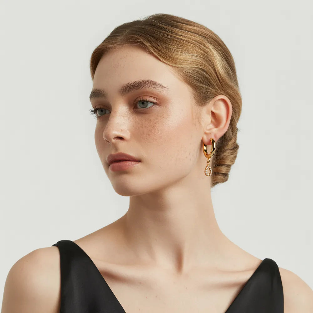 Model looking away while wearing the sophisticated Aria Pavé Teardrop Hoops