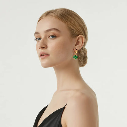 Model with wavy hair wearing the Clover Emerald Green Dangle Hoop Earrings