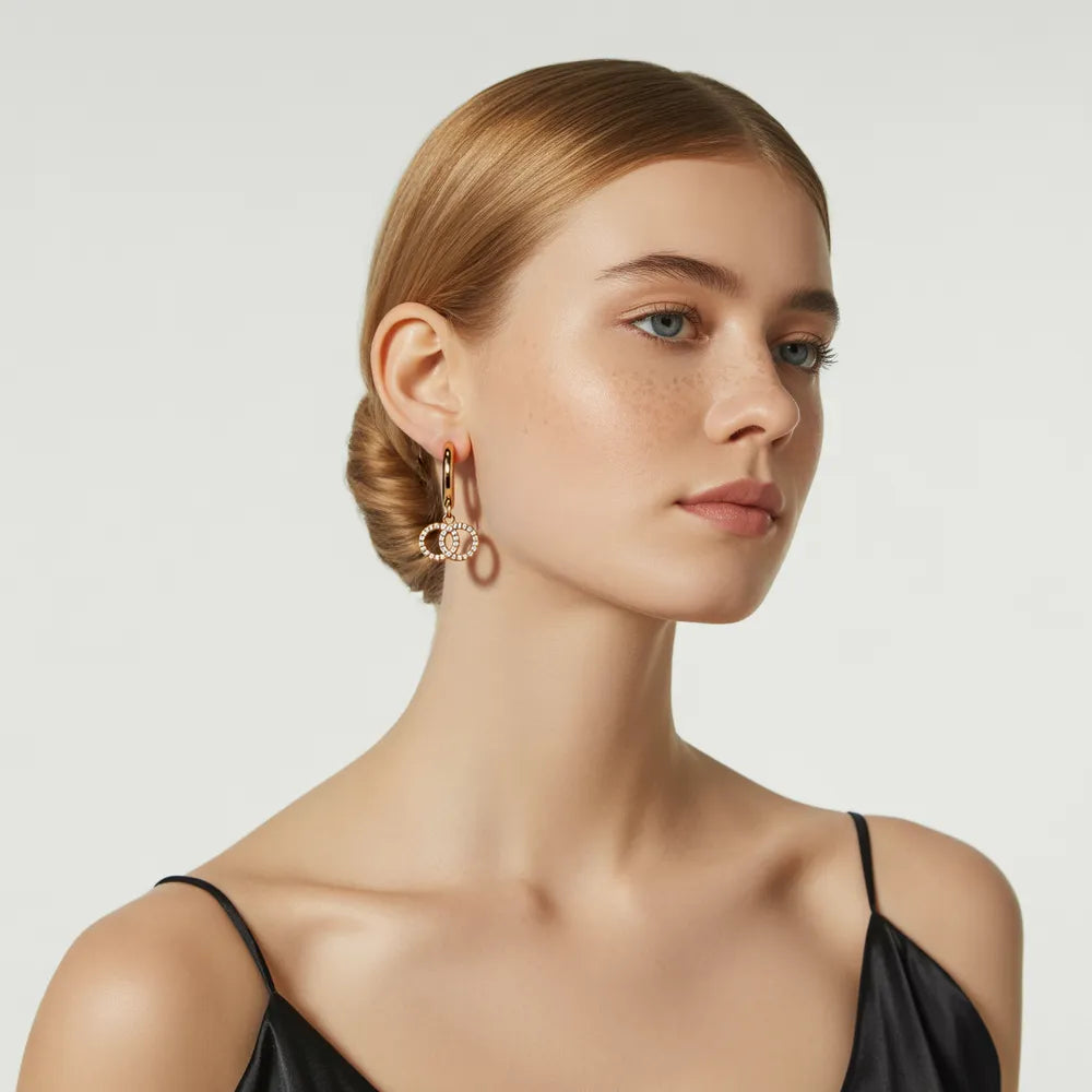 Woman showcasing the chic, modern look of the gold double ring hoop earrings