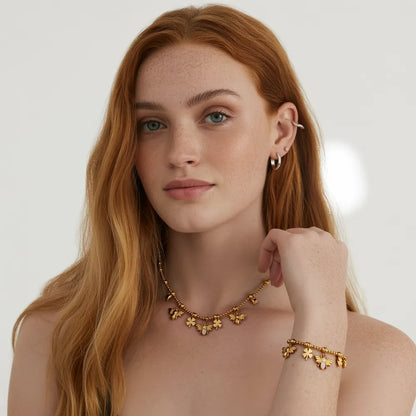 Model wearing the Melia Bee &amp; Clover Charm Necklace and Bracelet set in 18k gold.