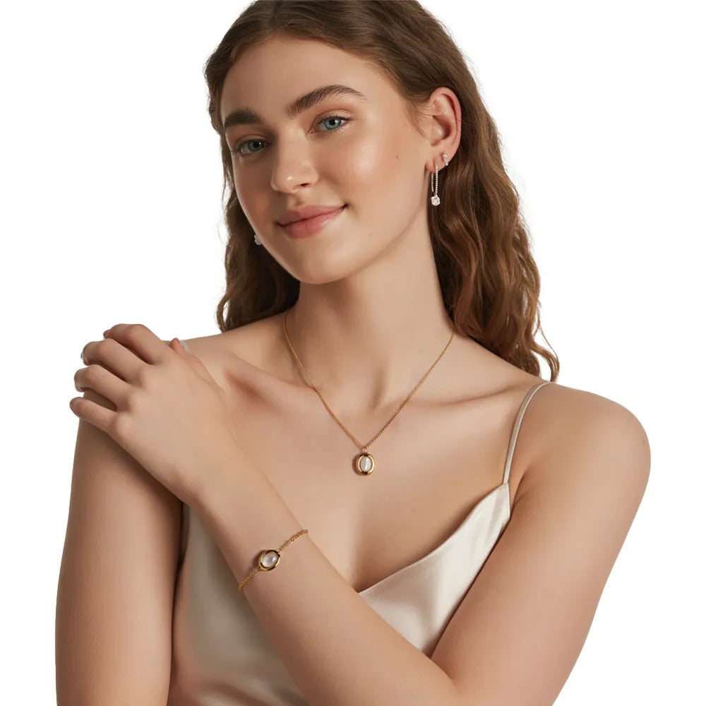 Model wearing the Serena Mother-of-Pearl Necklace and Bracelet set in 18k gold.